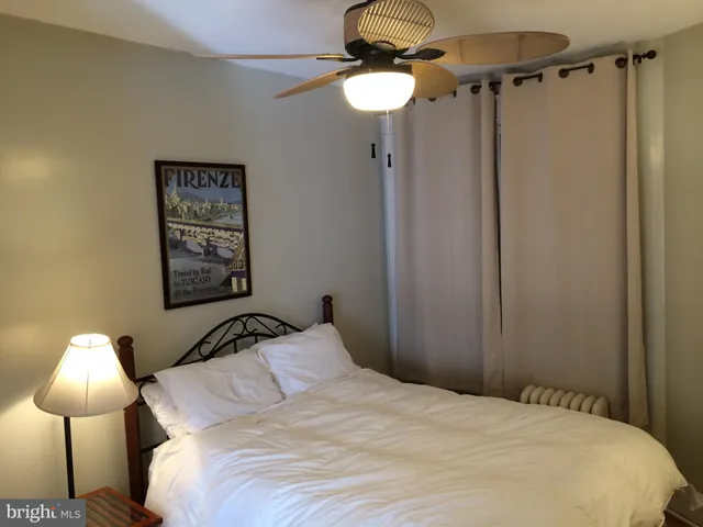 a bedroom with a bed and a lamp