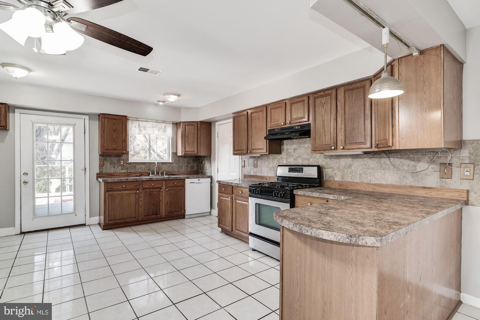 645 Wilby Road Sicklerville, NJ 08081 - Photo 8 of 24 a kitchen with stainless steel appliances granite countertop a stove sink and cabinets