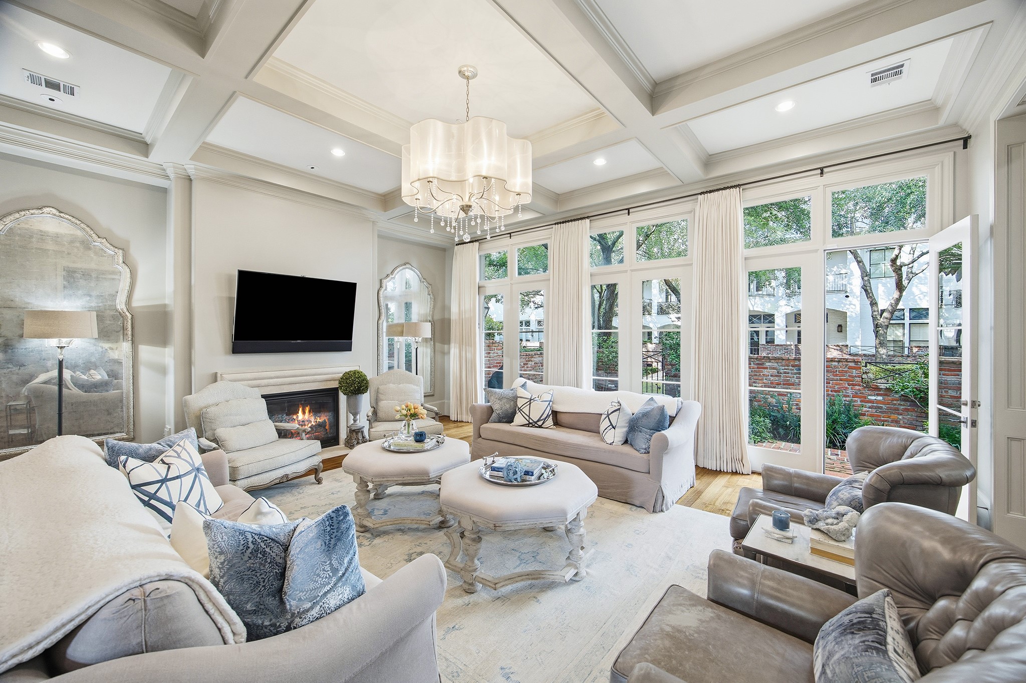 a living room with patio furniture and a flat screen tv