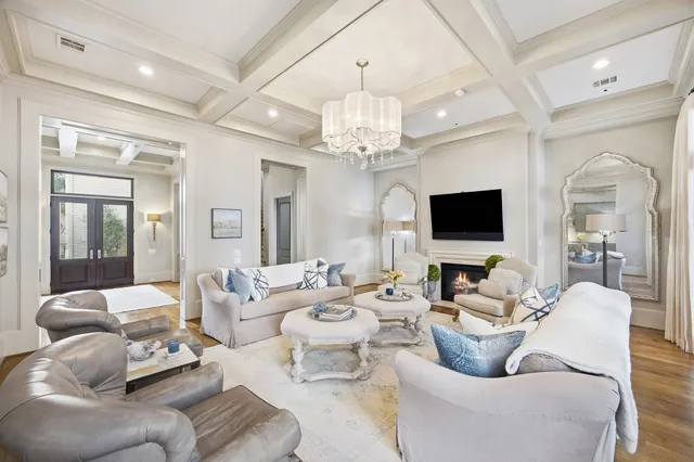 a living room with furniture or chandelier and a flat screen tv