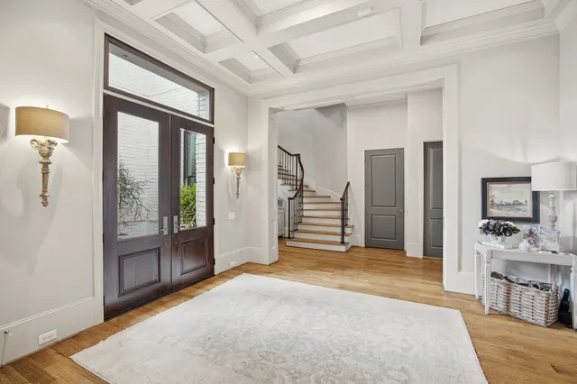 a view of a livingroom with wooden floor and furniture