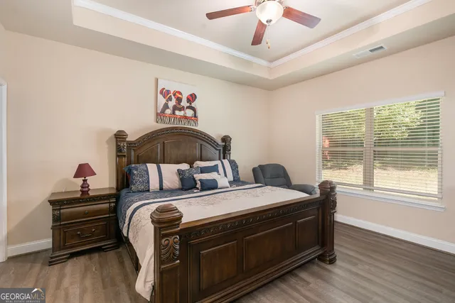 a bedroom with a bed and a large window