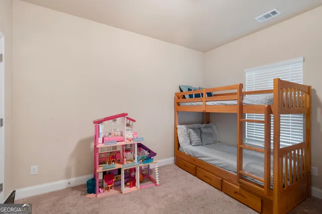 a bedroom with bunk beds and a baby crib
