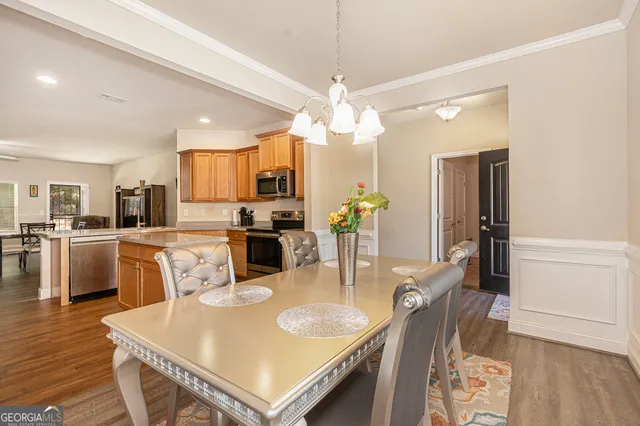 a large kitchen with kitchen island a stove a table and chairs