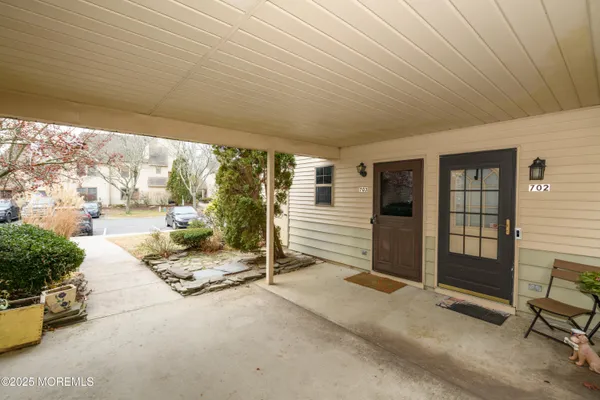 a building outdoor space with patio furniture and potted plants
