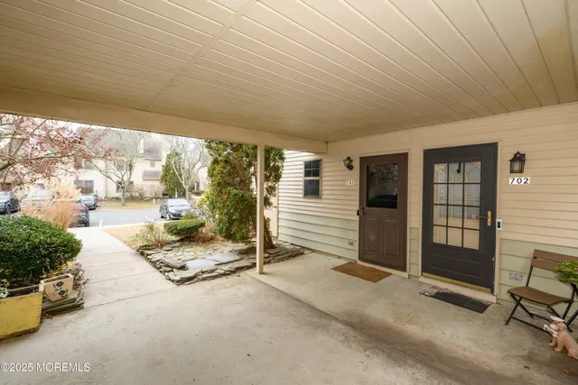a building outdoor space with patio furniture and potted plants