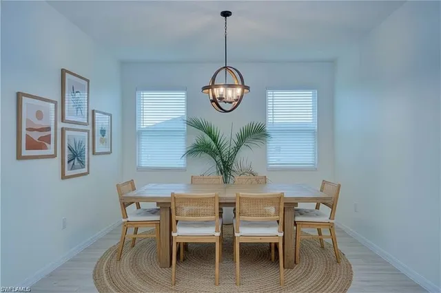 a dining room with furniture and a chandelier