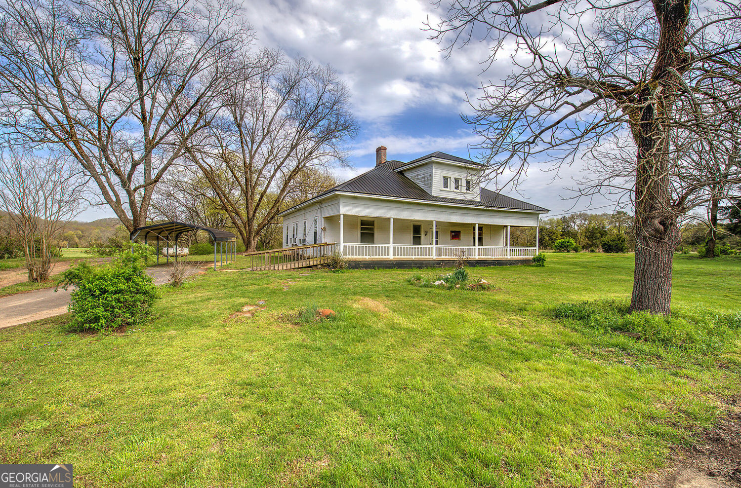 a front view of a building with a garden