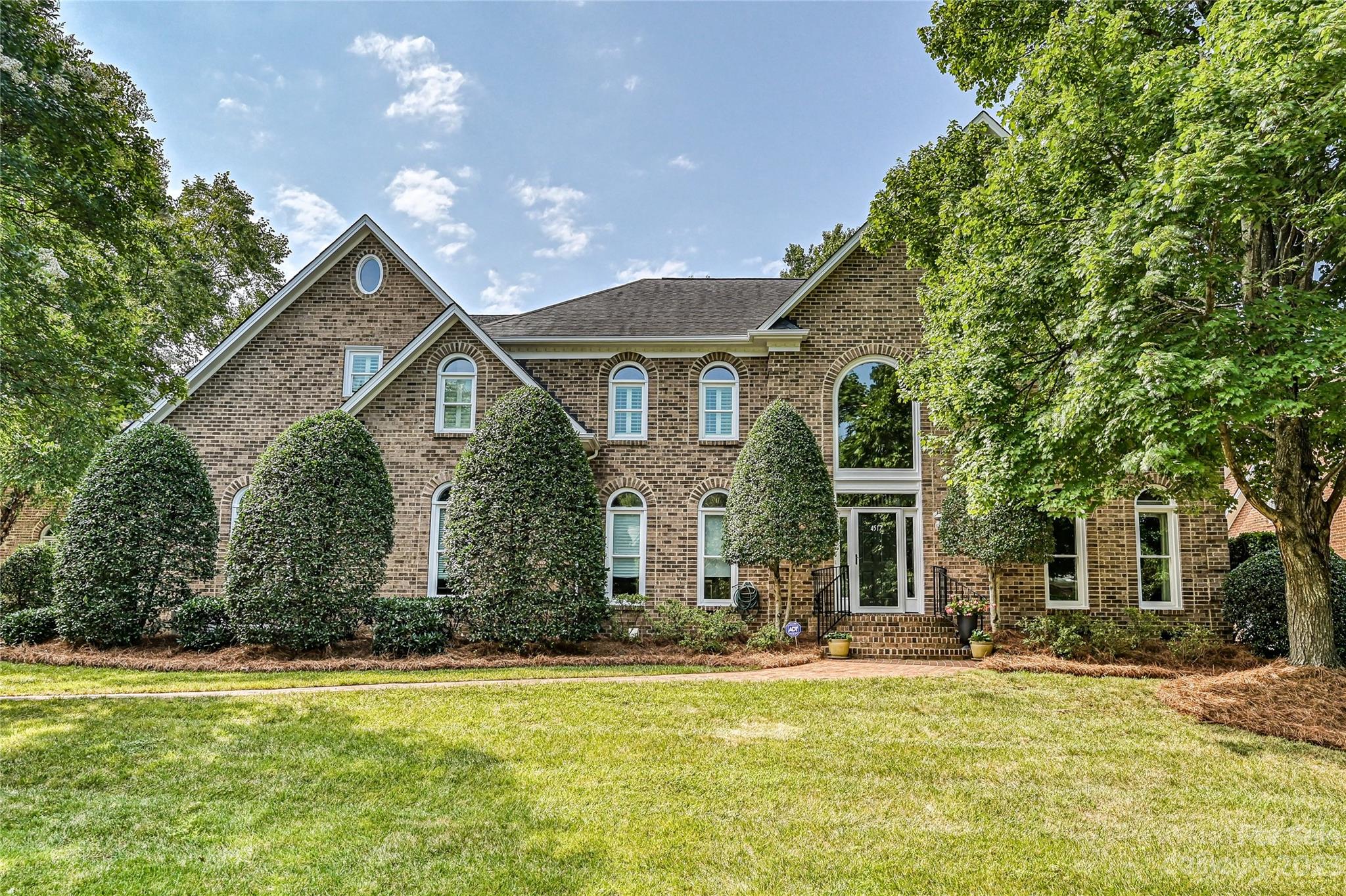 a front view of house with yard and green space