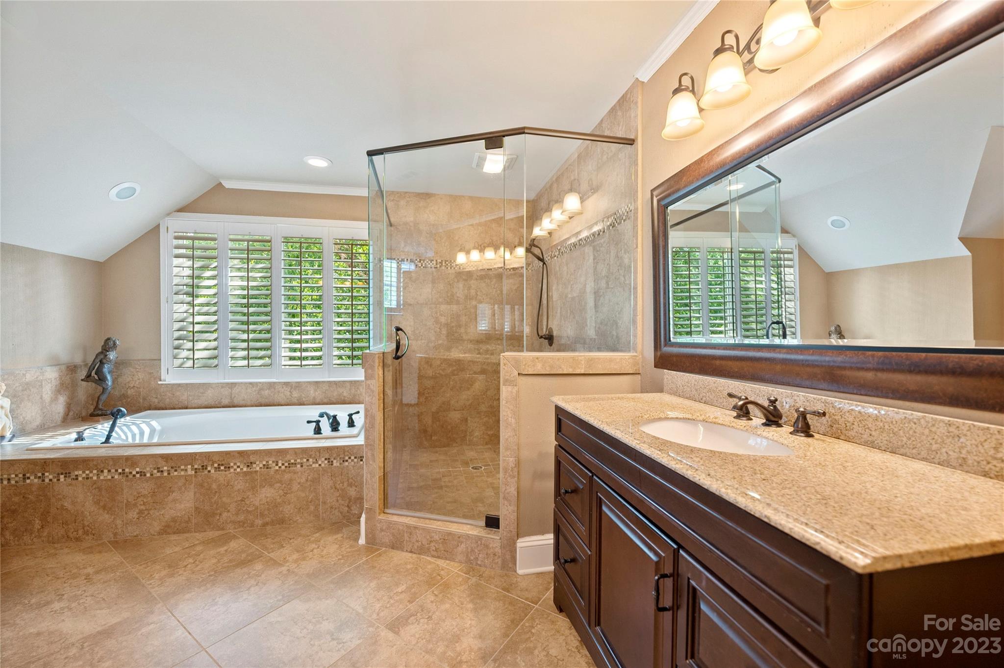 4517 Binfords Ridge Road Charlotte, NC 28226 - Photo 29 of 47 a bathroom with a tub a sink and a large mirror