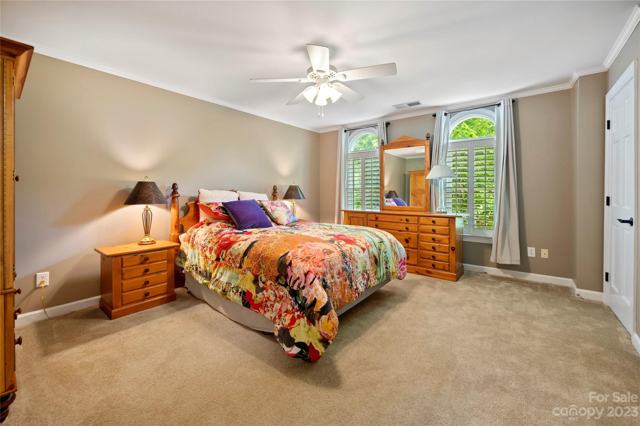 4517 Binfords Ridge Road Charlotte, NC 28226 - Photo 32 of 47 a bed room with a bed and a chandelier