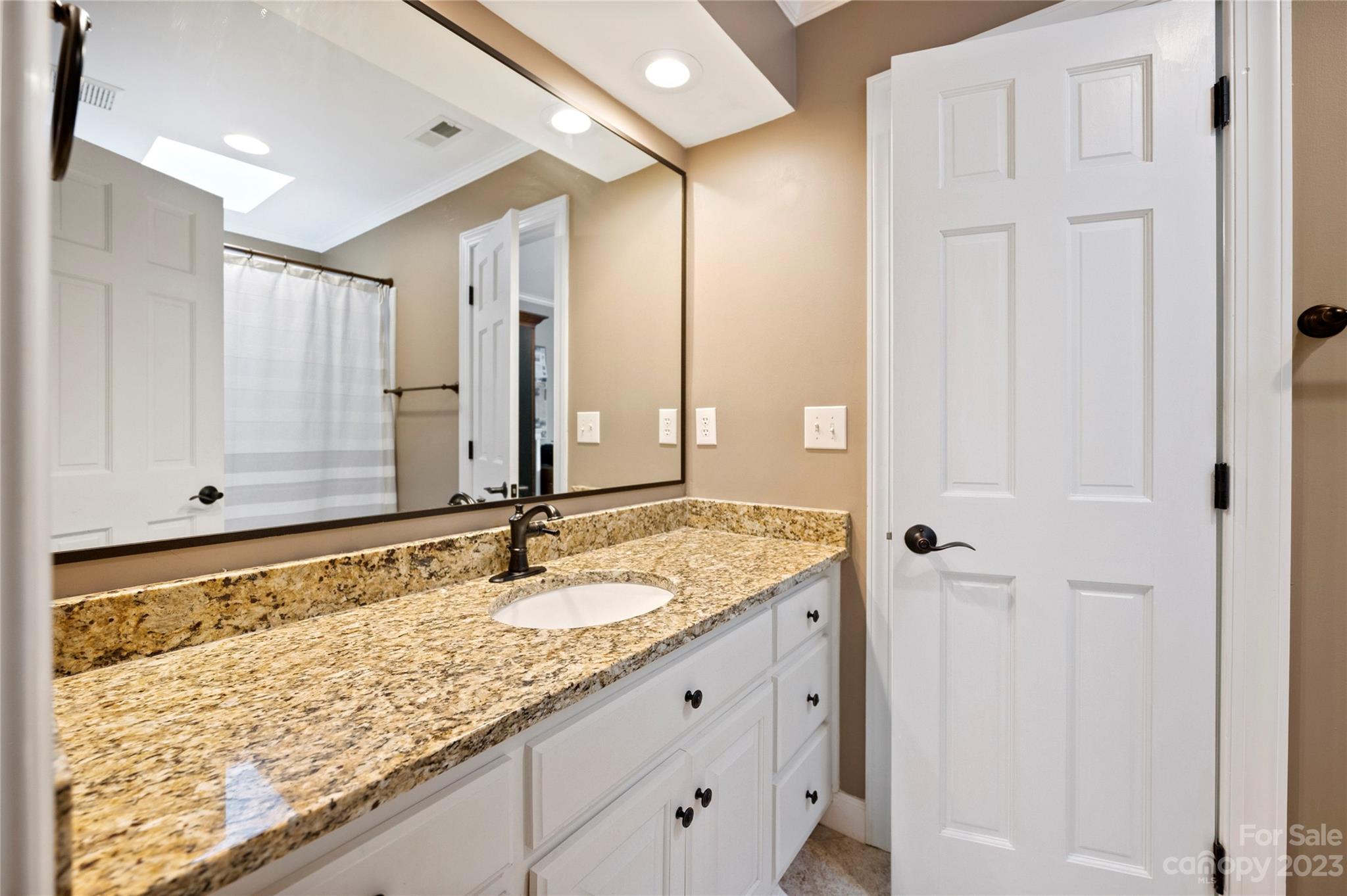 4517 Binfords Ridge Road Charlotte, NC 28226 - Photo 33 of 47 a bathroom with a granite countertop sink and a mirror