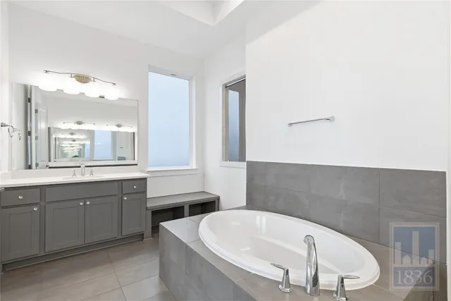 a bathroom with a bathtub and a sink