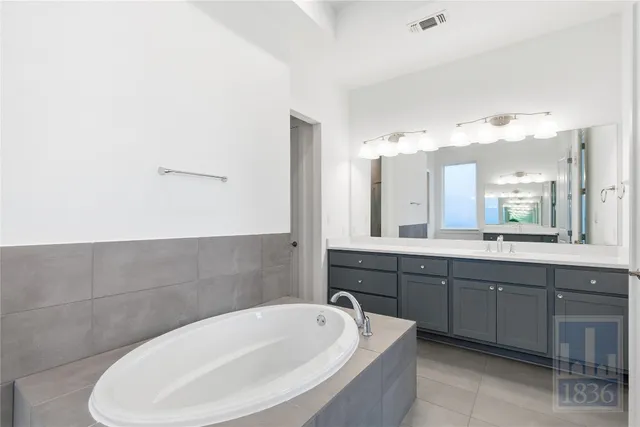 a bathroom with a bathtub and a sink