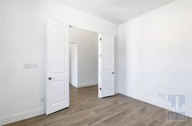 an empty room with wooden floor