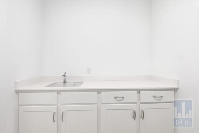 a bathroom with a sink and cabinets