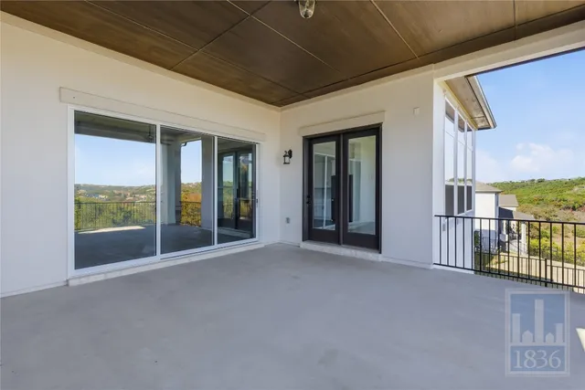 a view of a porch with furniture and floor to ceiling window
