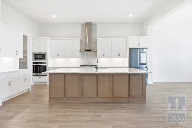a kitchen with kitchen island cabinets and oven