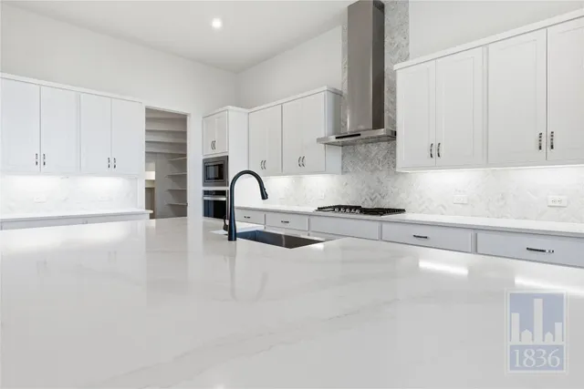 a kitchen with stainless steel appliances a refrigerator sink and cabinets