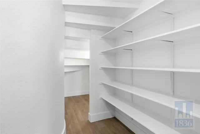 a view of walk in closet with empty racks