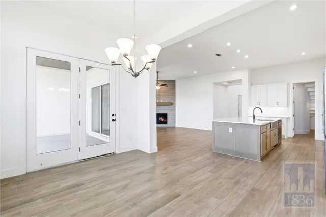 a view of a kitchen with a refrigerator and a sink