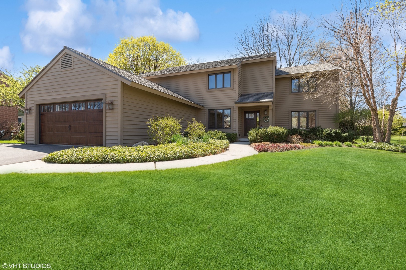 a front view of house with yard and green space