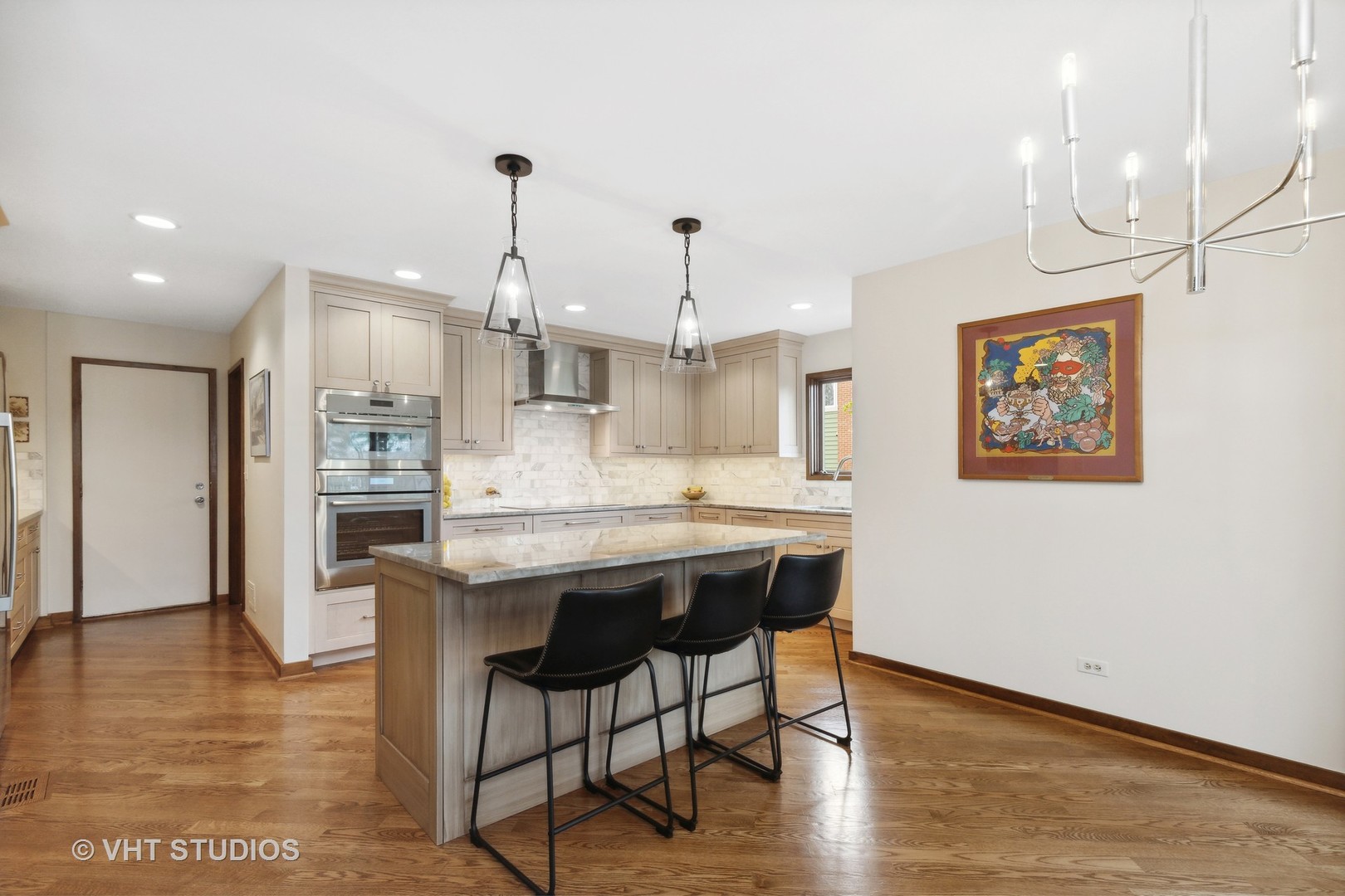 770 Valley Road Lake Forest, IL 60045 - Photo 9 of 29 a kitchen with stainless steel appliances kitchen island granite countertop a table chairs and a refrigerator