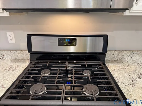 an empty room with wooden floor ceiling fan and windows