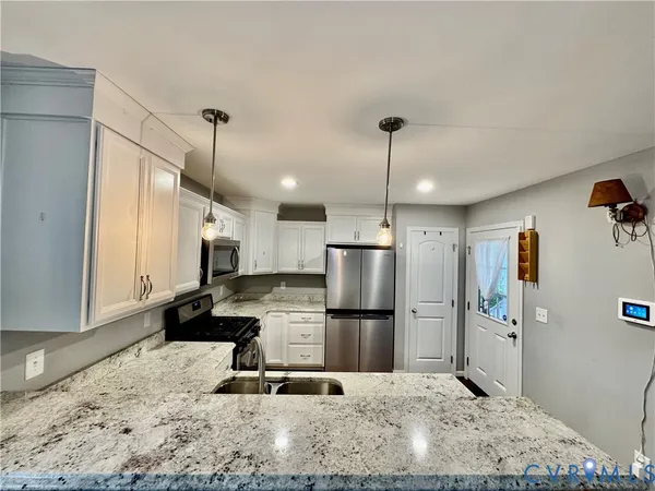 a bathroom with a granite countertop sink a mirror and a shower