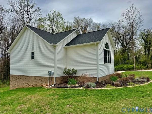 a front view of a house with a garden and yard