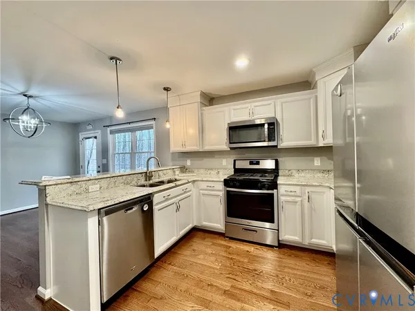 a view of a kitchen with wooden floor