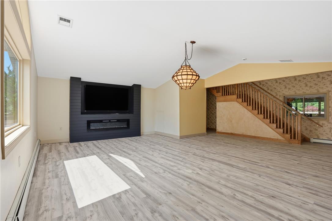 6271 Batman Road Zionsville, PA 18092 - Photo 23 of 100 A striking black accent wall with a modern fireplace defines this versatile gathering space.