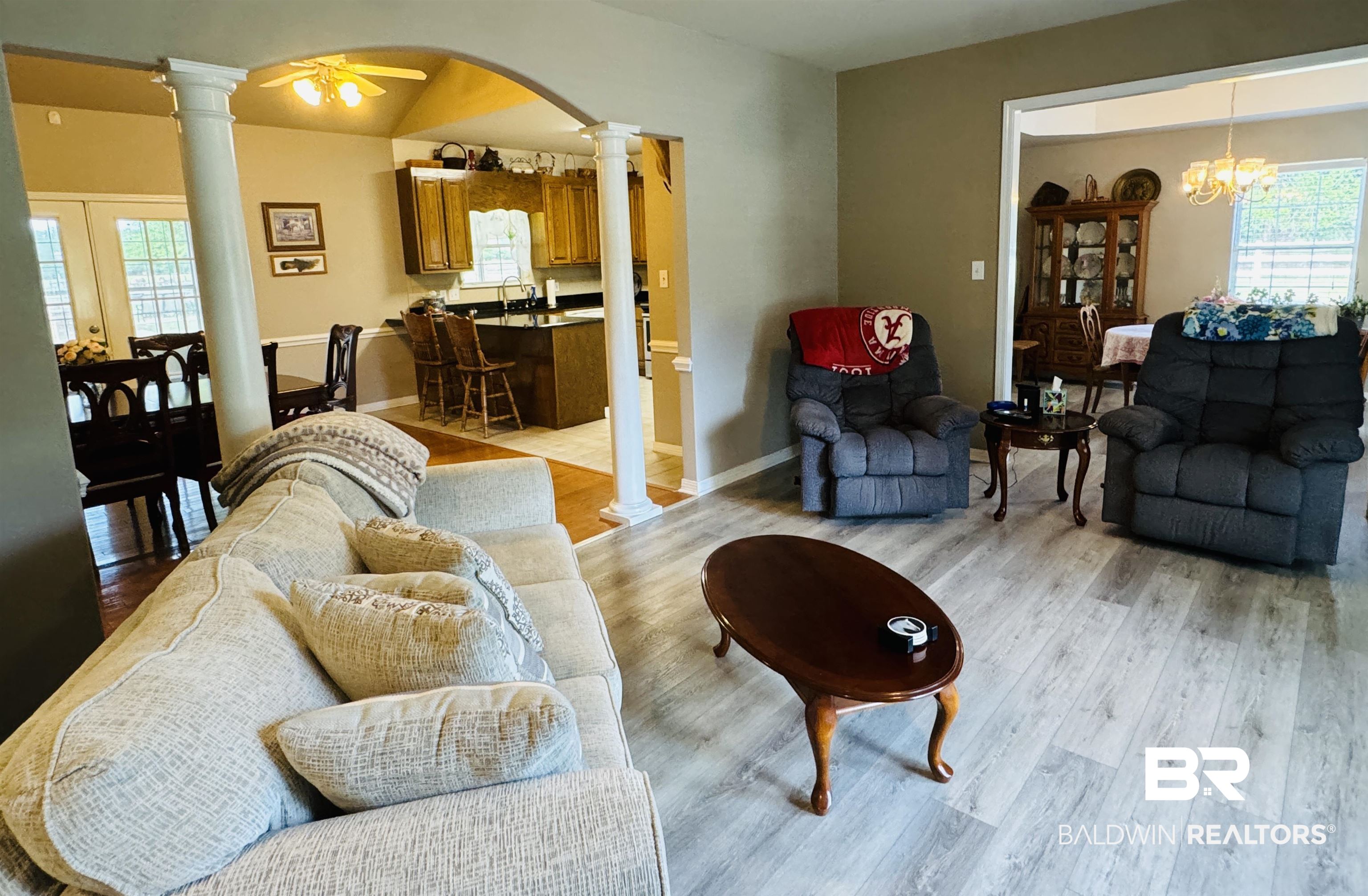 13795 White Road Silverhill, AL 36576 - Photo 22 of 99 Living area with decorative columns, light wood-style flooring, a ceiling fan, and suspended lighting