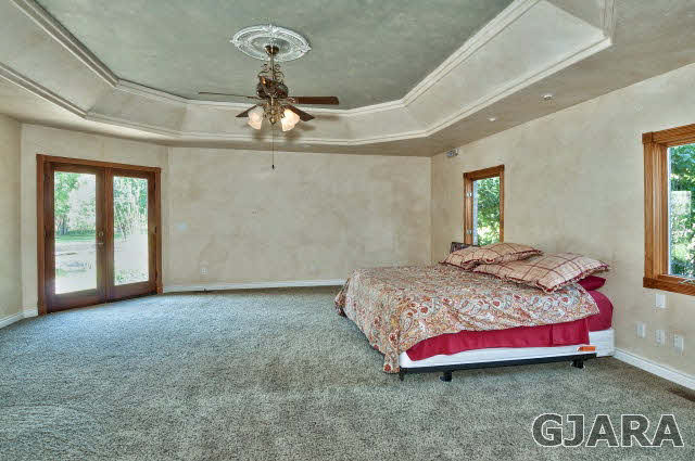 887 25 Road Grand Junction, CO 81505 - Photo 17 of 42 a bedroom with a bed and window