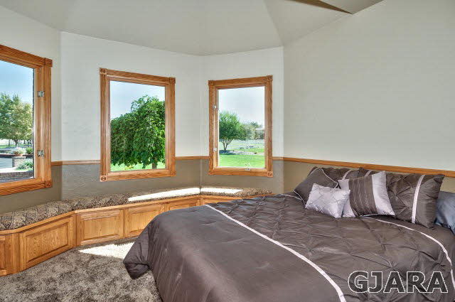 887 25 Road Grand Junction, CO 81505 - Photo 22 of 42 a bedroom with a bed and a large window