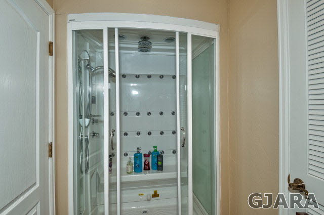 887 25 Road Grand Junction, CO 81505 - Photo 29 of 42 a bathroom with a glass door and shower