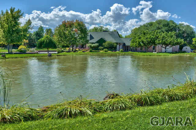 887 25 Road Grand Junction, CO 81505 - Photo 38 of 42 a view of a lake with houses in back