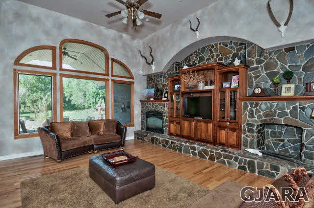 887 25 Road Grand Junction, CO 81505 - Photo 9 of 42 a living room with furniture a fireplace and a flat screen tv