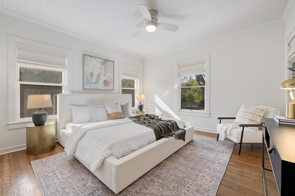 3808 Avenue F Austin, TX 78751 - Photo 13 of 22 Primary bedroom with wood flooring, multiple windows and custom window treatments, a ceiling fan, and ornamental molding
