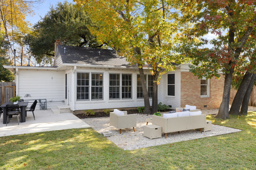 3808 Avenue F Austin, TX 78751 - Photo 18 of 22 HUGE yard featuring a patio, an outdoor living space, brick siding, and roof with shingles