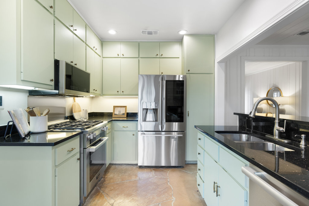 3808 Avenue F Austin, TX 78751 - Photo 8 of 22 Kitchen with new appliances (including a Miele range), dark stone counters, and green cabinetry