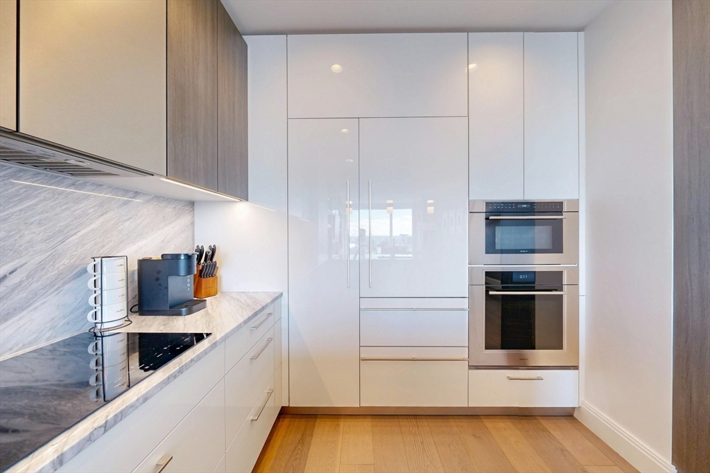 240 Devonshire Street, Unit 4505 Boston, MA 02110 - Photo 11 of 42 a kitchen with stainless steel appliances a stove and a refrigerator