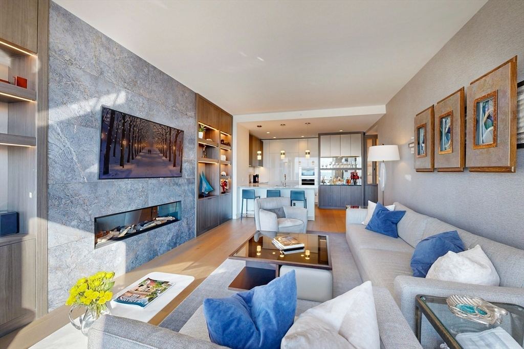 240 Devonshire Street, Unit 4505 Boston, MA 02110 - Photo 5 of 42 a living room with furniture and a fireplace