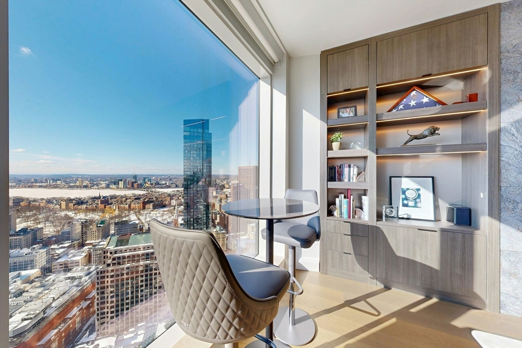 240 Devonshire Street, Unit 4505 Boston, MA 02110 - Photo 7 of 42 a living room with fireplace furniture and a rug