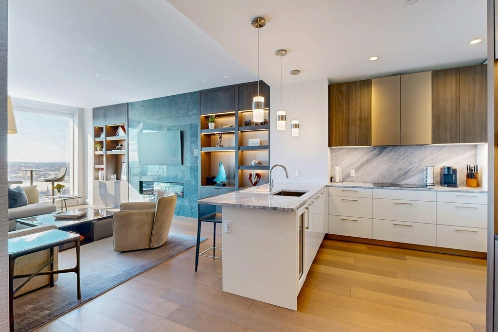 240 Devonshire Street, Unit 4505 Boston, MA 02110 - Photo 8 of 42 a kitchen with stainless steel appliances granite countertop a sink and cabinets