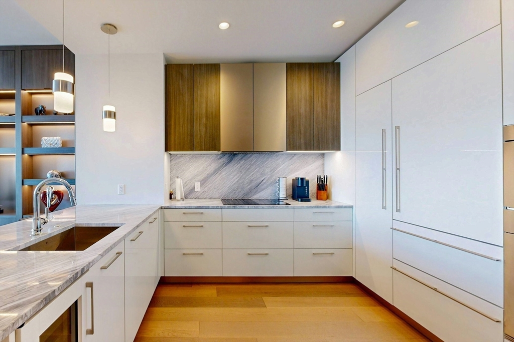 240 Devonshire Street, Unit 4505 Boston, MA 02110 - Photo 9 of 42 a kitchen with stainless steel appliances granite countertop a sink and a refrigerator