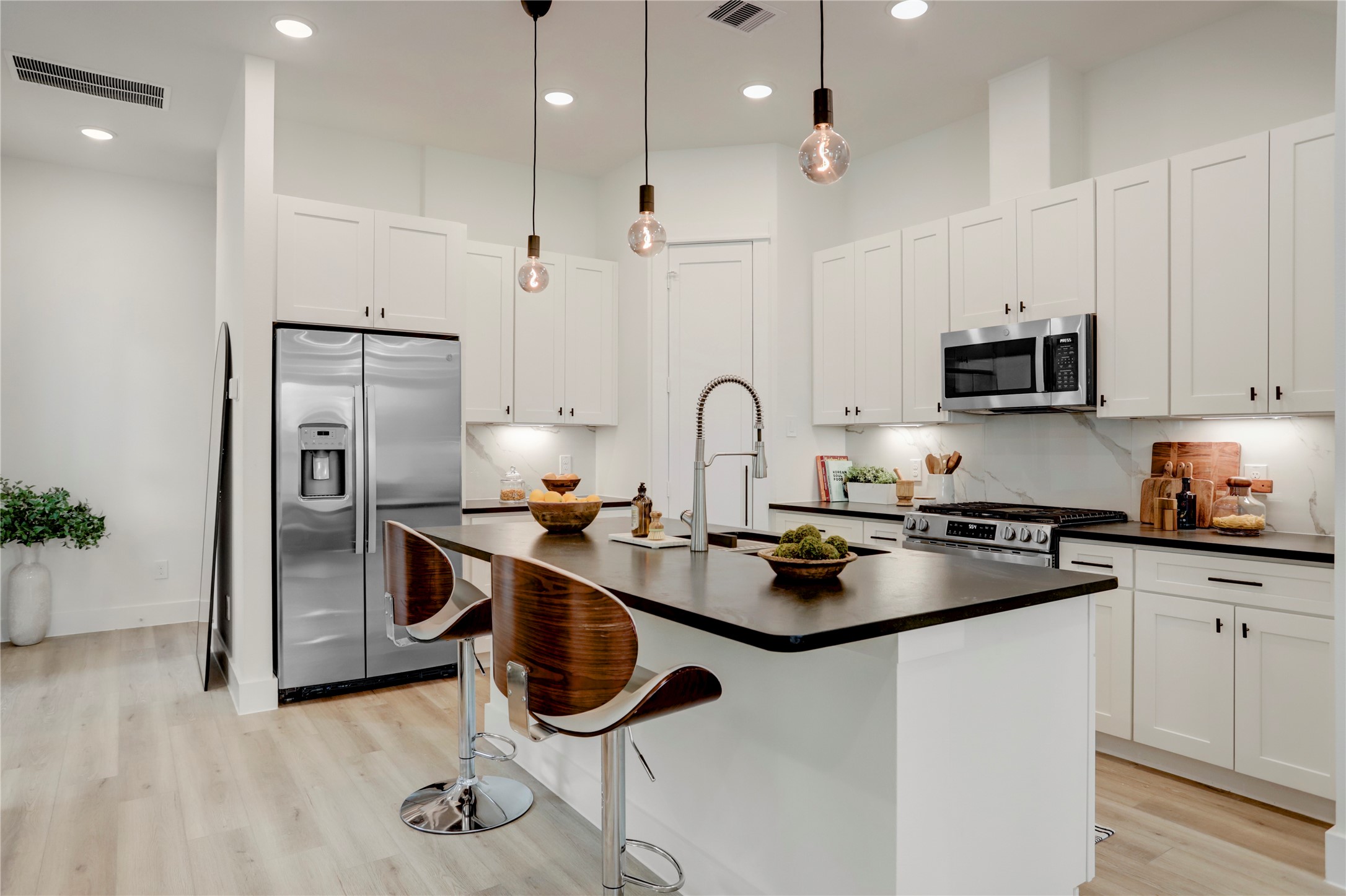 311 Marcella Street, Unit A Houston, TX 77091 - Photo 11 of 34 The kitchen has solid wood cabinets, walk-in pantry, and marble backsplash.