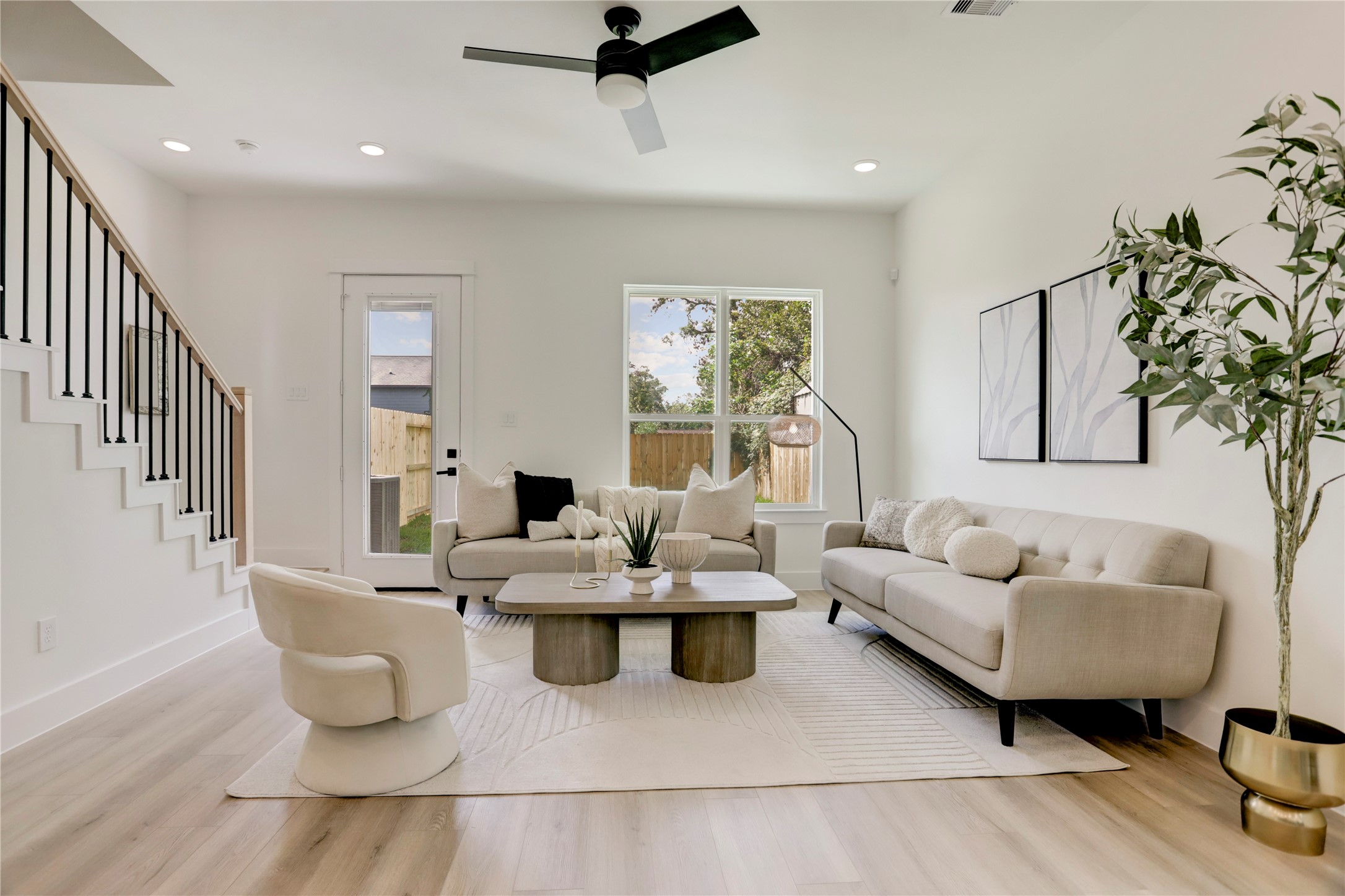 311 Marcella Street, Unit A Houston, TX 77091 - Photo 14 of 34 The 14x15 SF living room has a black Hunter fan. Double-glazed windows with Argon gas ensure superior insulation and reduced energy costs throughout the home.