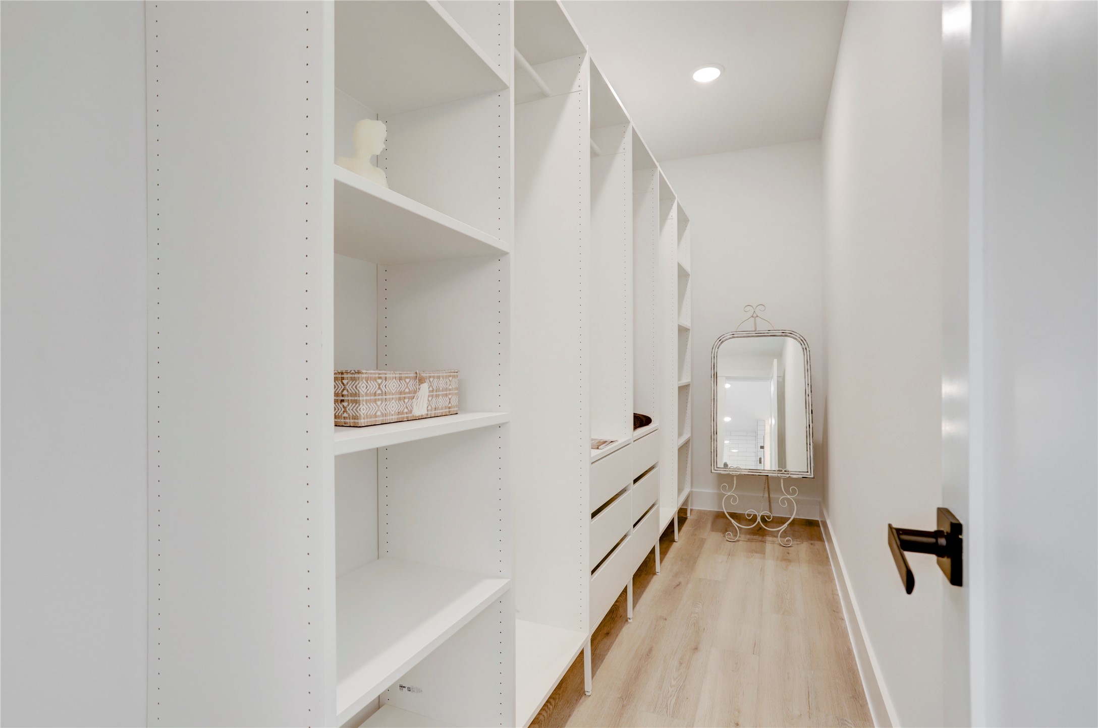 311 Marcella Street, Unit A Houston, TX 77091 - Photo 24 of 34 The spacious primary closet has custom built-in shelves and drawers.