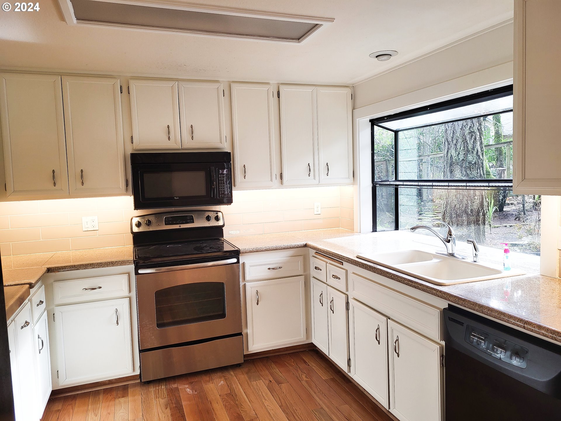 3431 Timberline Drive Eugene, OR 97405 - Photo 18 of 39 a kitchen with white cabinets appliances and a sink